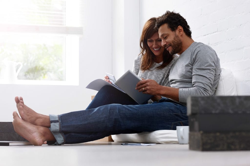 Mixed raced couple calculating their expenses.
