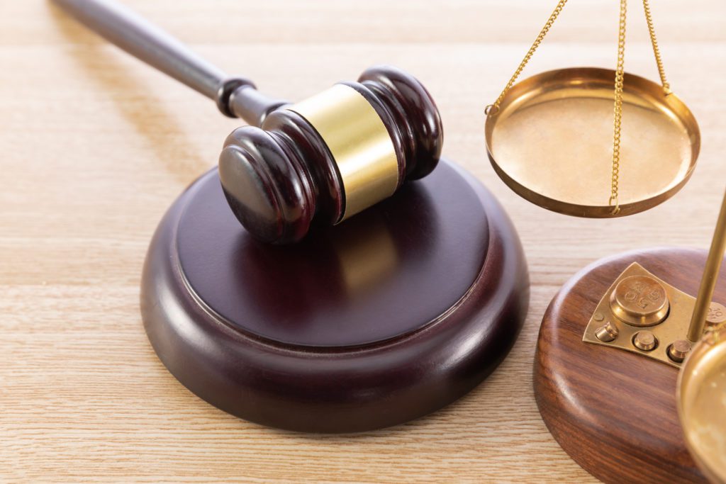 Gavel and Scales of Justice in a personal injury lawsuit settlement