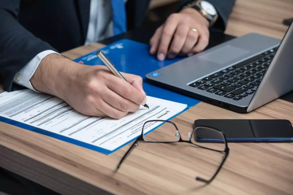 Man with computer reviewing riders in an annuity agreement