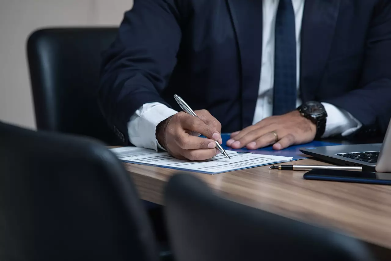 Man writing on office desk