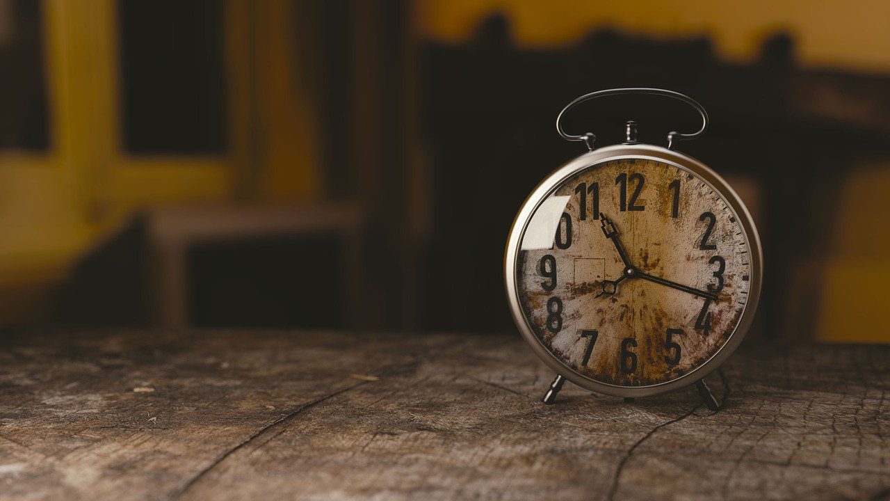 Old alarm clock on a wooden surface