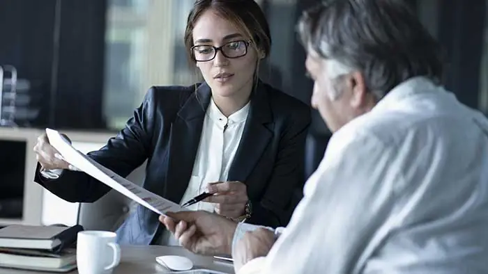 person consulting with his attorney at a desk