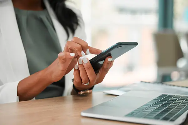 Woman's hands texting on phone