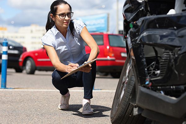 woman taking notes at accident scene