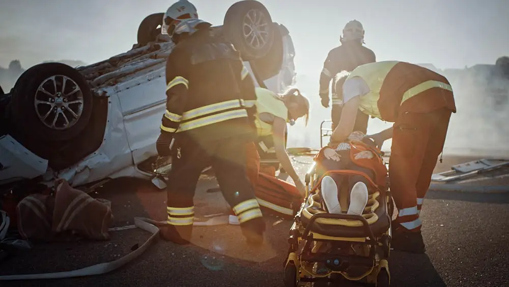 Paramedics assisting at a auto accident scene