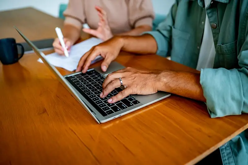 Person applying for pre-settlement funding on a laptop