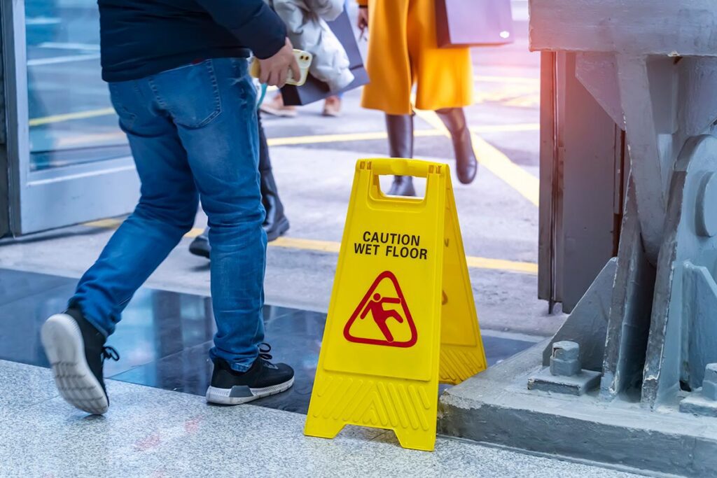 Person walking by wet floor sign